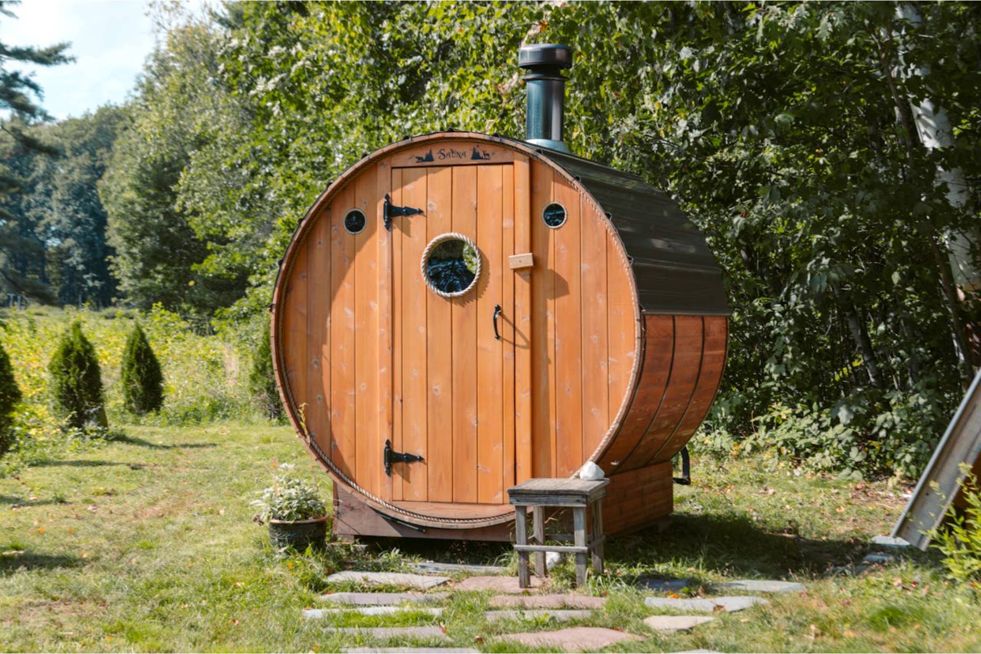 Image a barrel sauna in the forest which was assembled using a barrel sauna kit