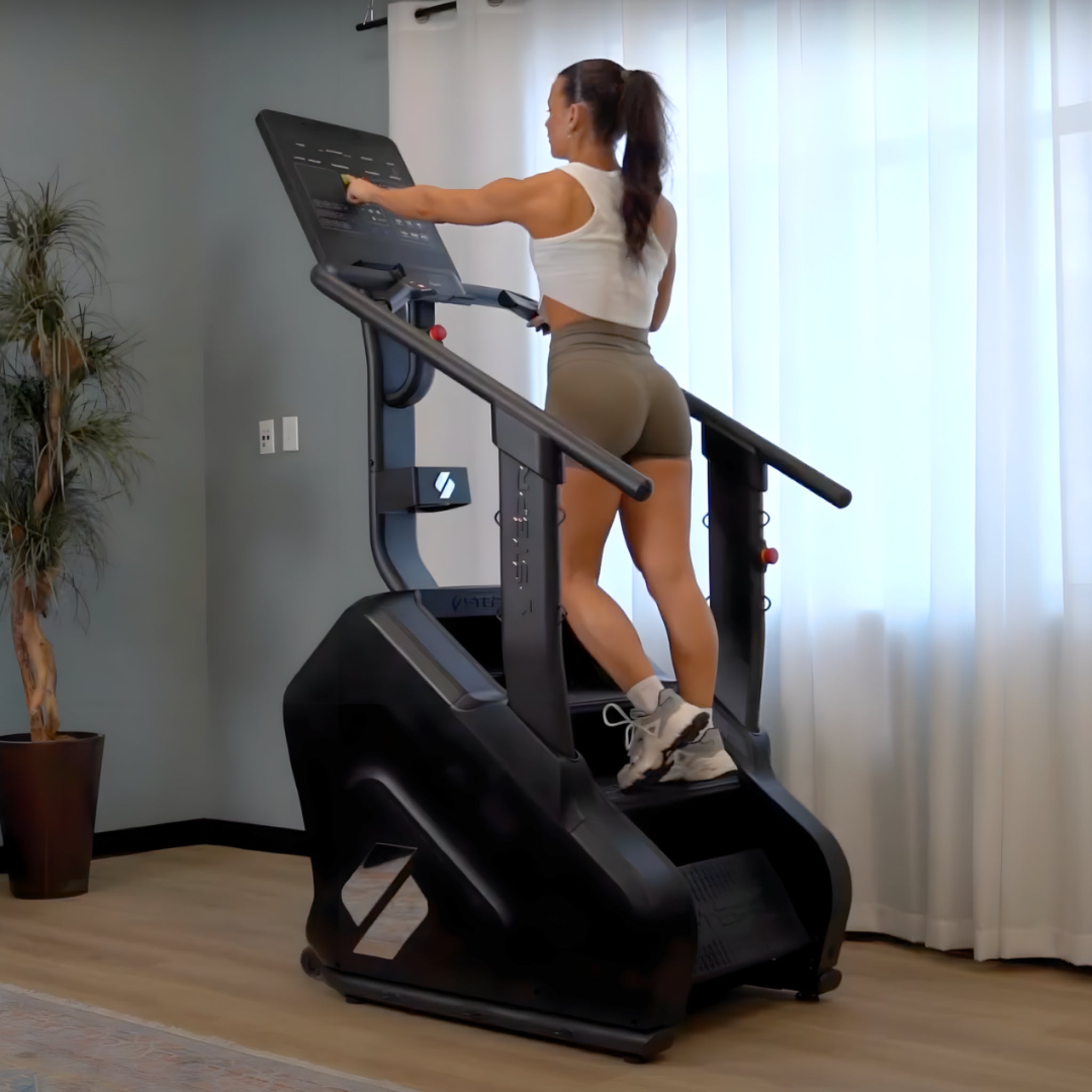 Woman using a stair stepr machine in a home setting