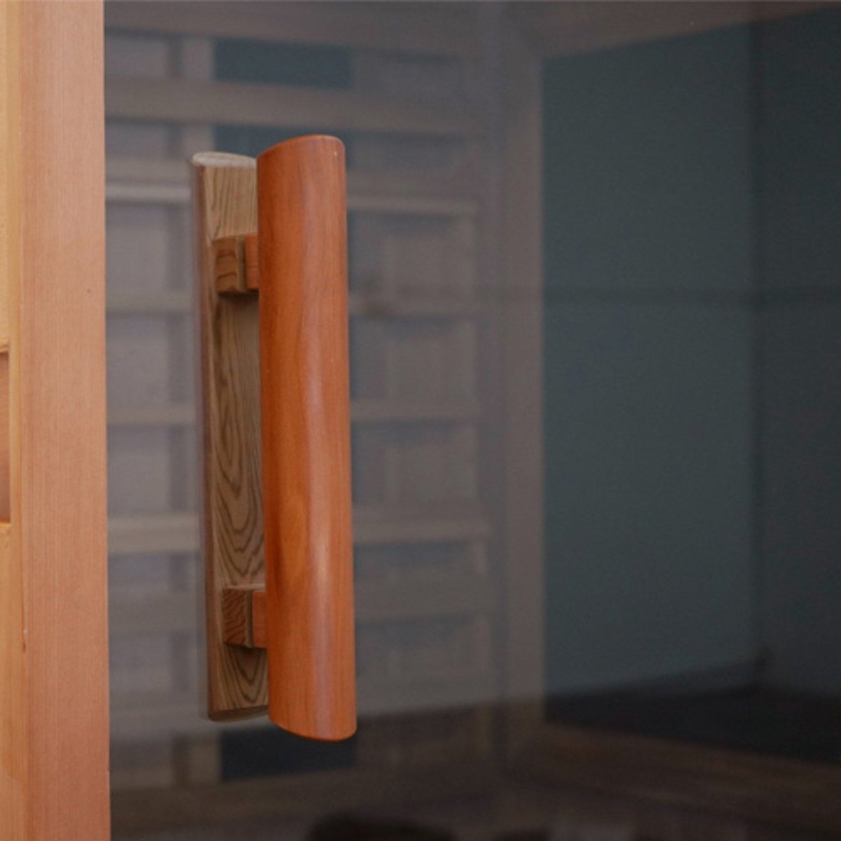 Side view of Finnmark FD-2 sauna highlighting door design and wood handle.