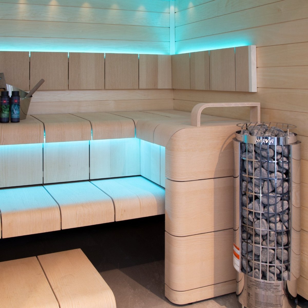 Harvia Cilindro PC60 sauna heater installed in sauna with ambient blue lighting
