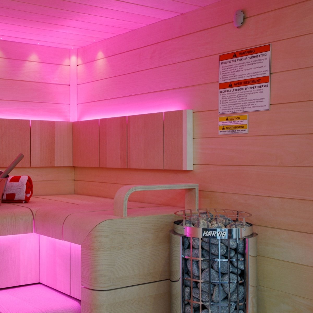 Harvia Cilindro PC90 electric sauna heater installed in sauna with colored lighting