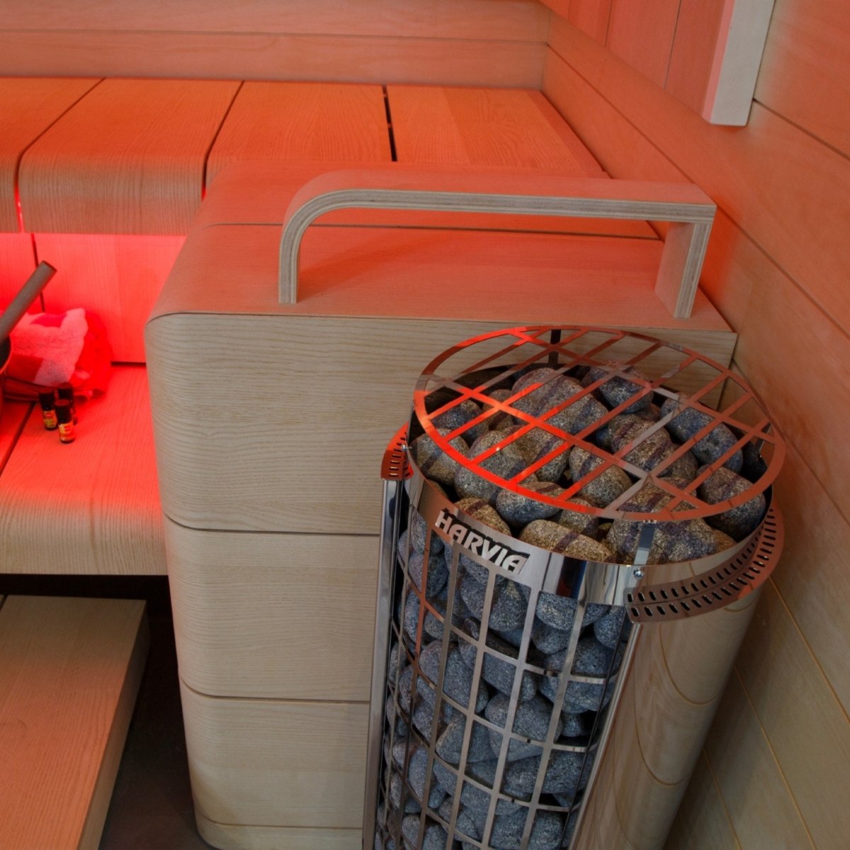 Harvia Cilindro PC90 sauna heater installed in sauna with warm ambient lighting