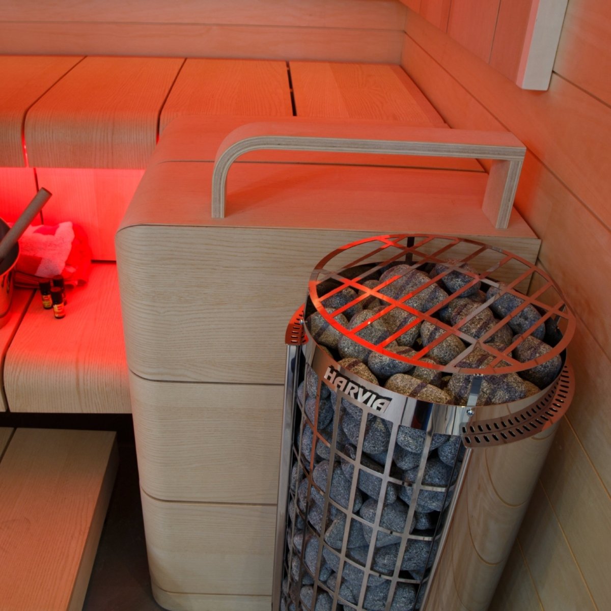 Harvia Cilindro PC90E electric sauna heater installed in sauna with ambient colored lighting