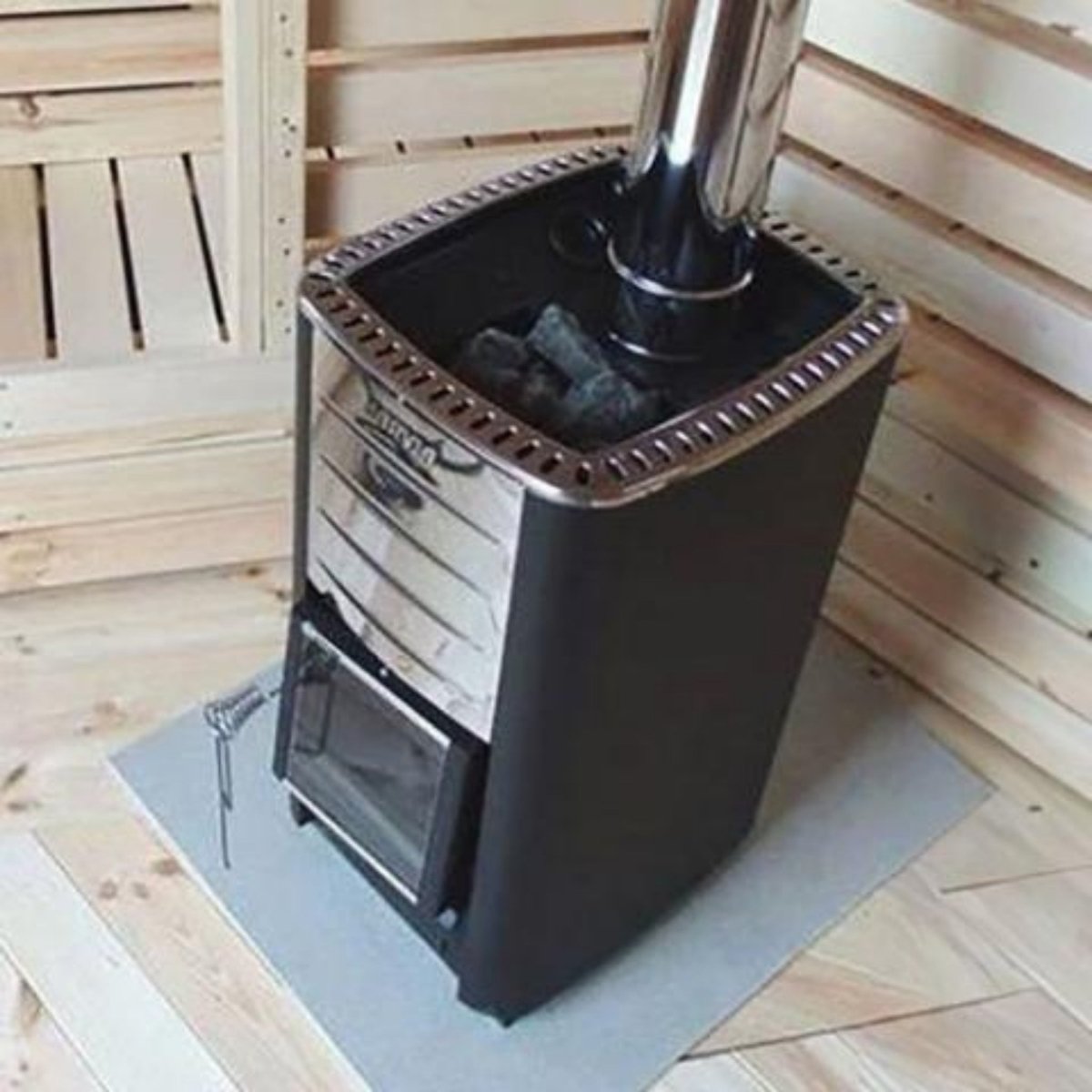 Harvia M3 wood-burning sauna heater installed inside a traditional wood sauna