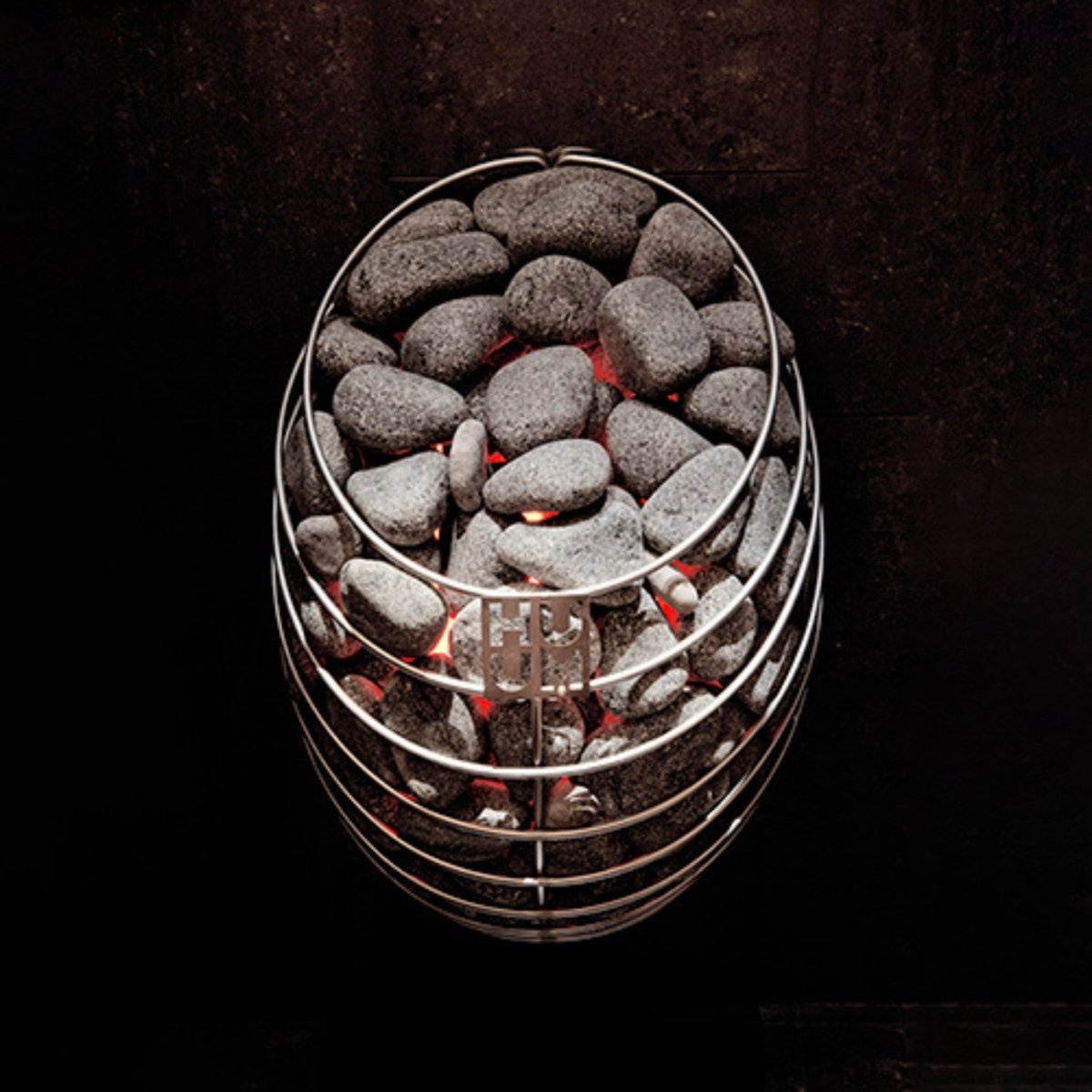 Close-up of HUUM DROP 6 electric sauna heater with glowing stones.