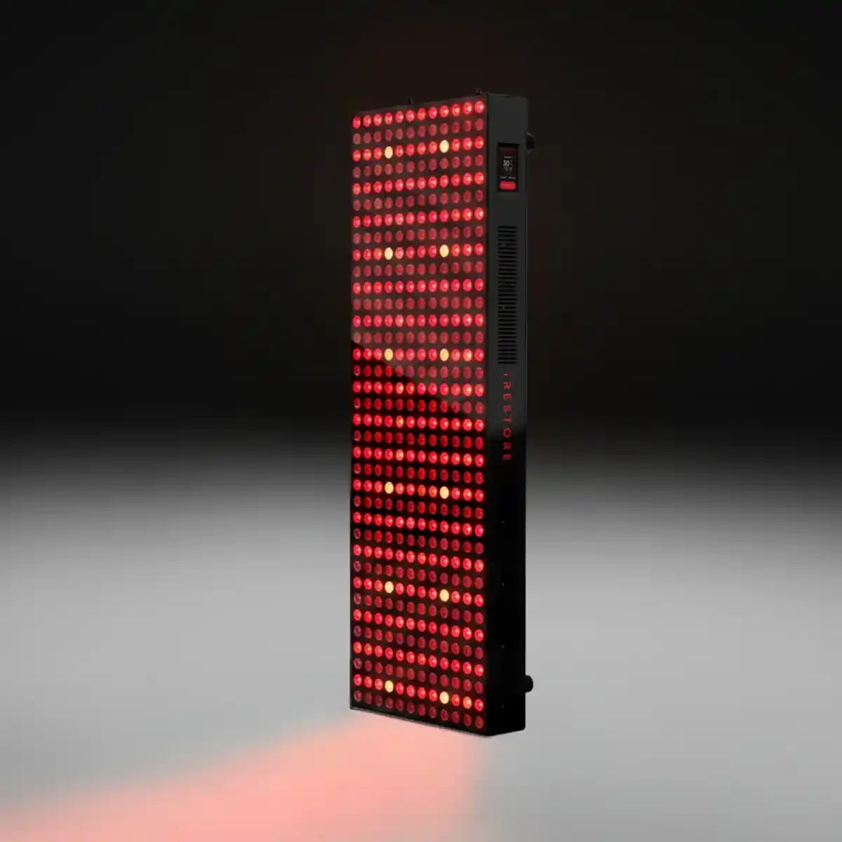iRESTORE Apex Elite 2160 red light therapy panel with illuminated red and near-infrared LEDs