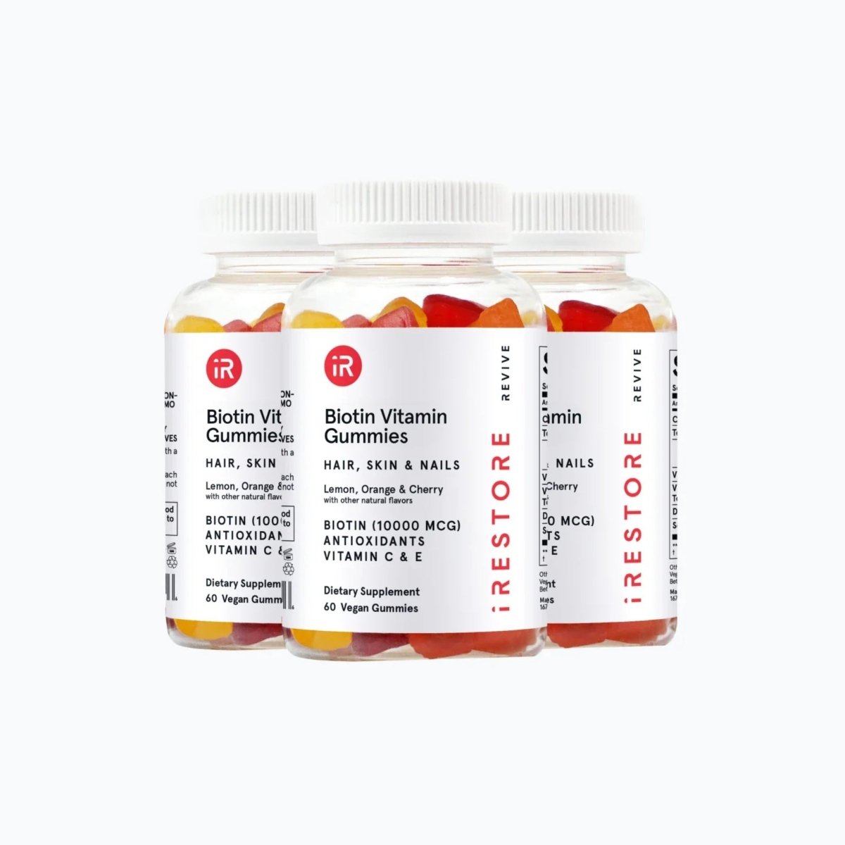 Two bottles of iRestore Biotin Gummies for daily hair nutrition