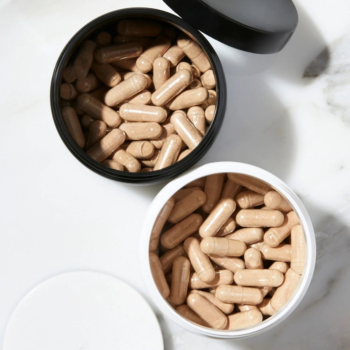 Capsules of iRestore Hair Growth Formula displayed in wooden bowl