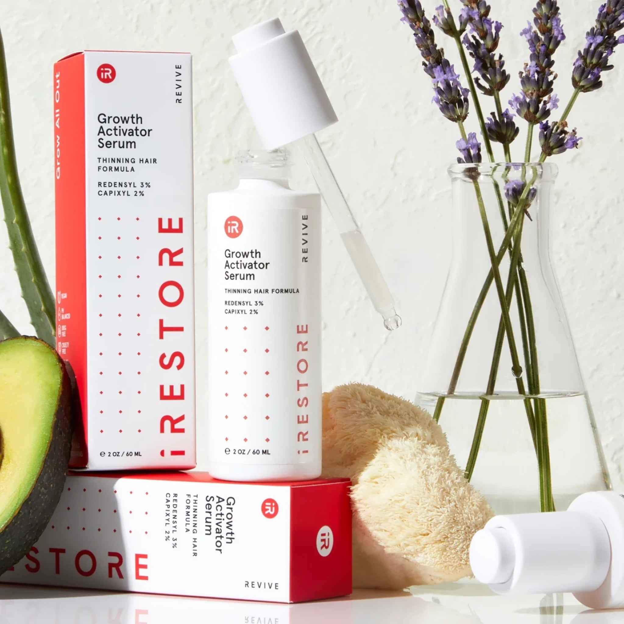 Close-up of iRestore Hair Growth Serum dropper for precise scalp application