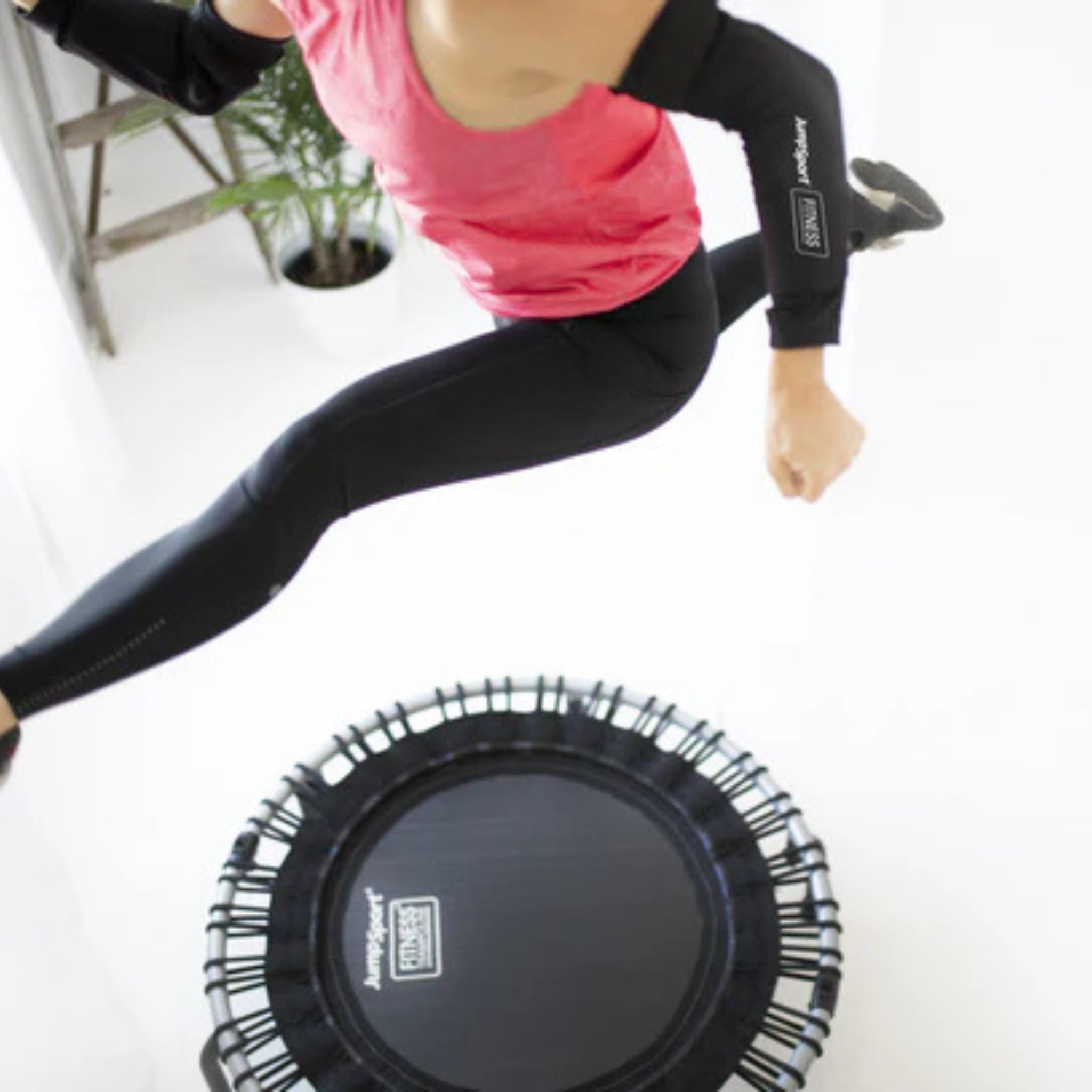 Jumpsport handlebar cover being installed on trampoline for workout safety