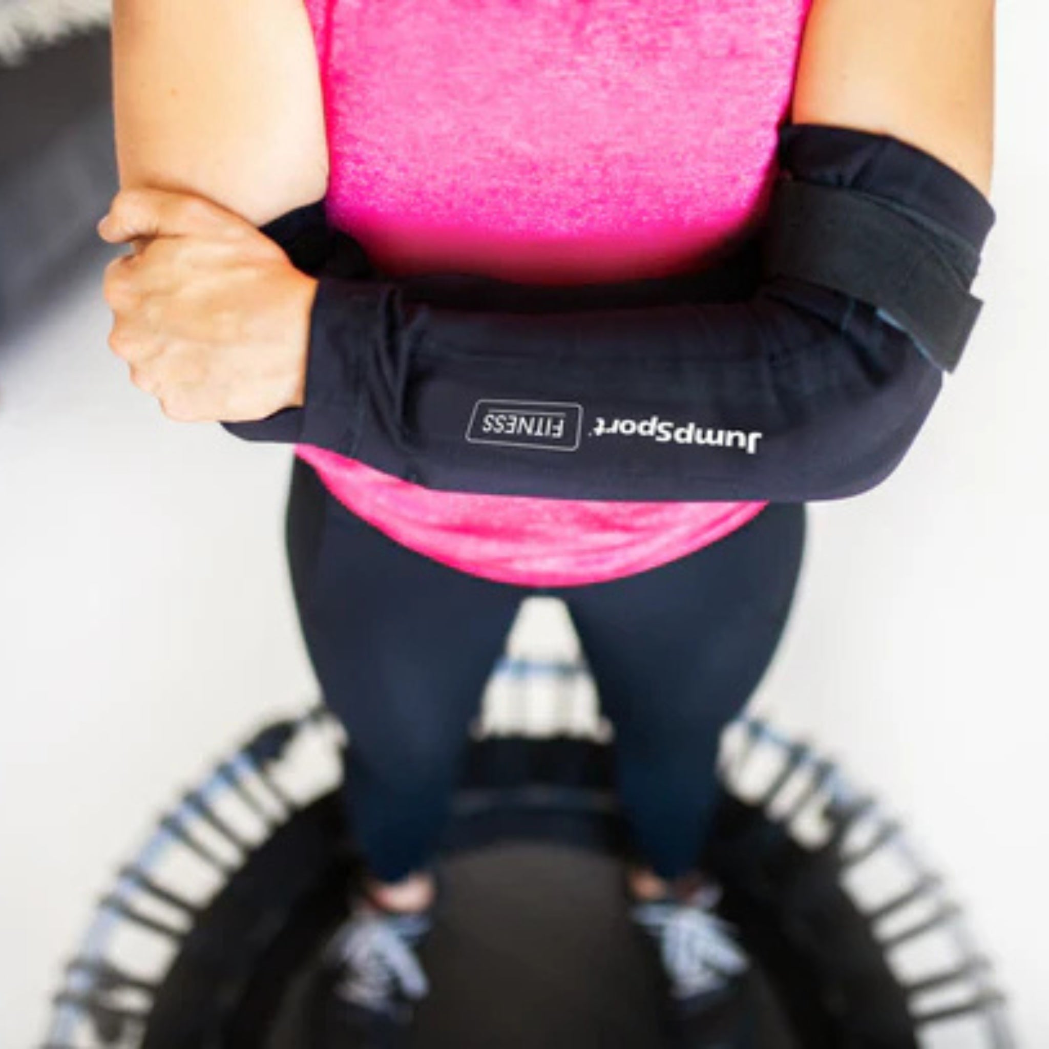 Woman using Jumpsport trampoline handlebar cover during fitness exercise