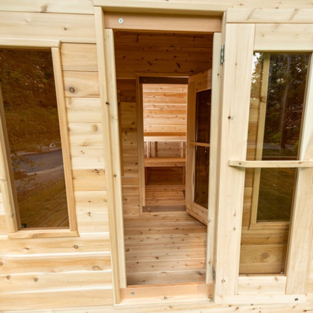 Leisurecraft CT Georgian Cabin Sauna with changeroom, cedar exterior, open door showing interior benches and entryway.
