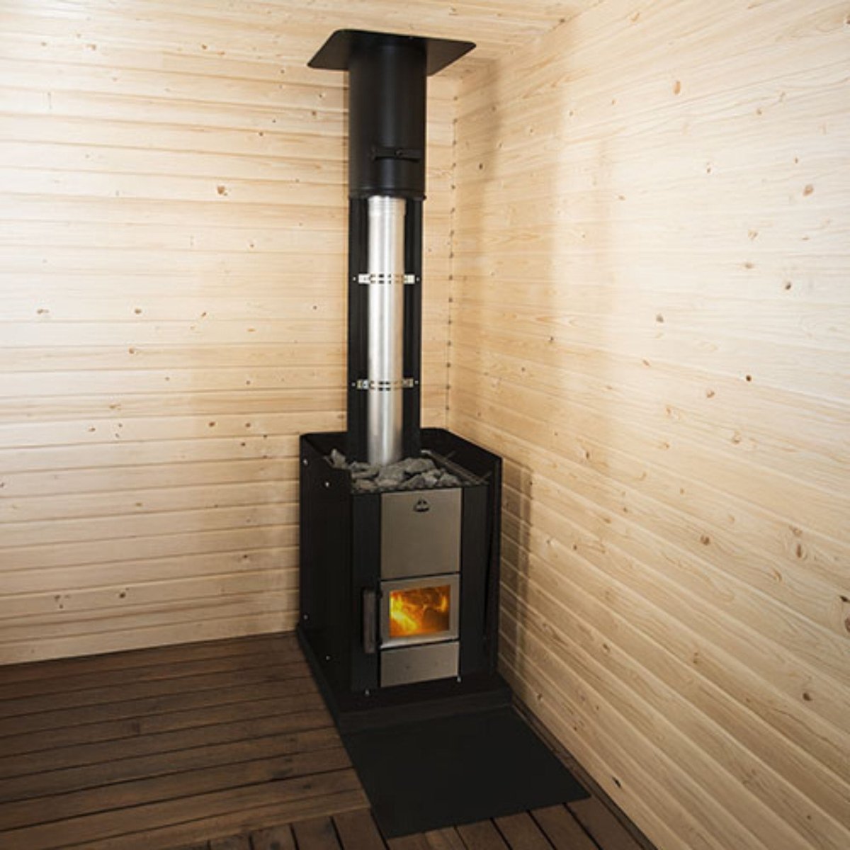 Narvi Kuru wood-burning sauna stove installed in a traditional sauna interior with visible fire through glass door and chimney pipe