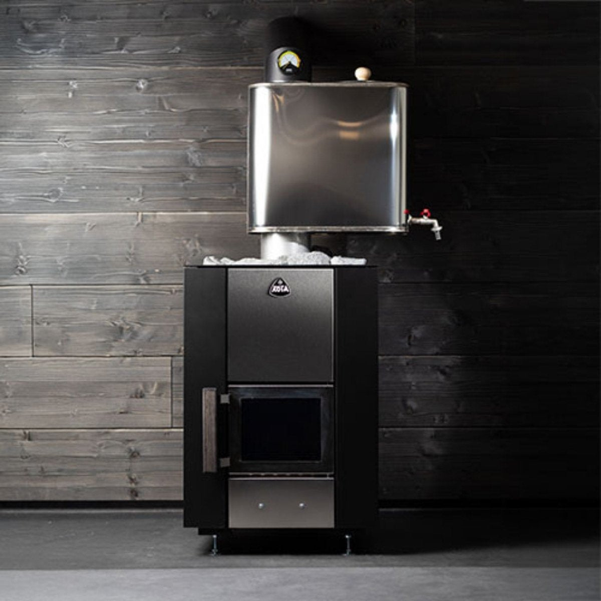 Narvi Kuru wood-burning sauna stove installed in a traditional sauna interior with external water tank mounted above