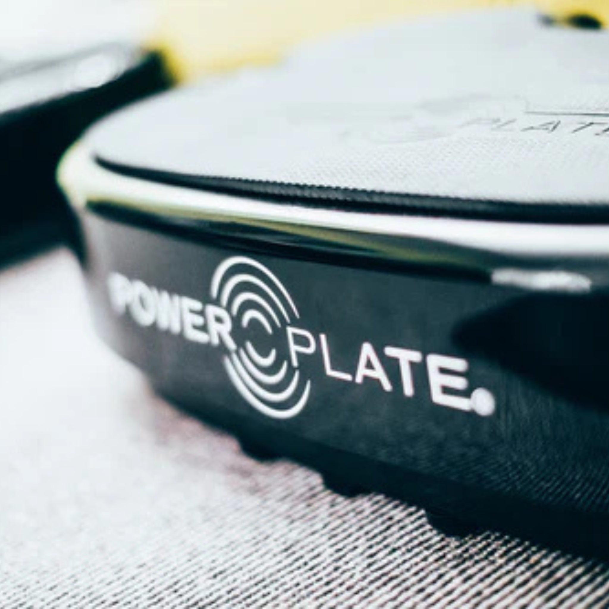 Power Plate vibration platform close-up showing brand logo detail