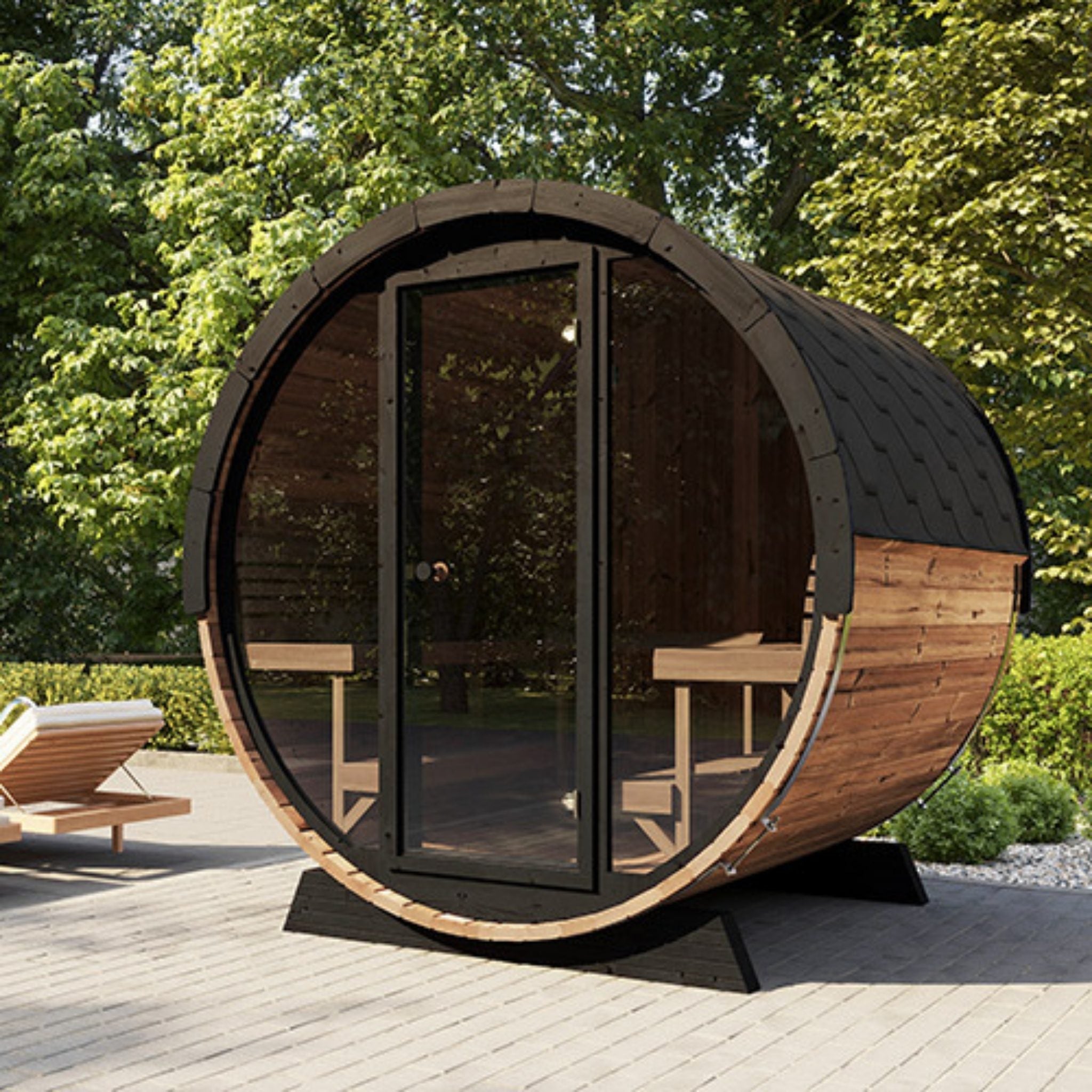 SaunaLife EE8G outdoor barrel sauna placed on patio with scenic greenery backdrop.