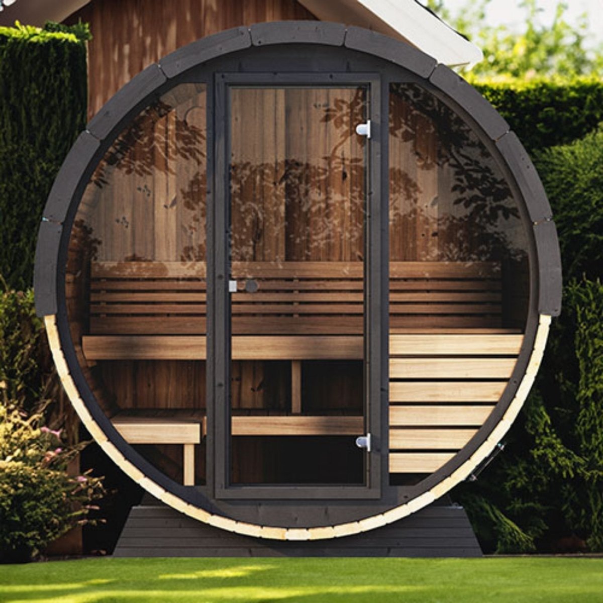 SaunaLife EE6G barrel sauna positioned on patio with modern outdoor setting and greenery.