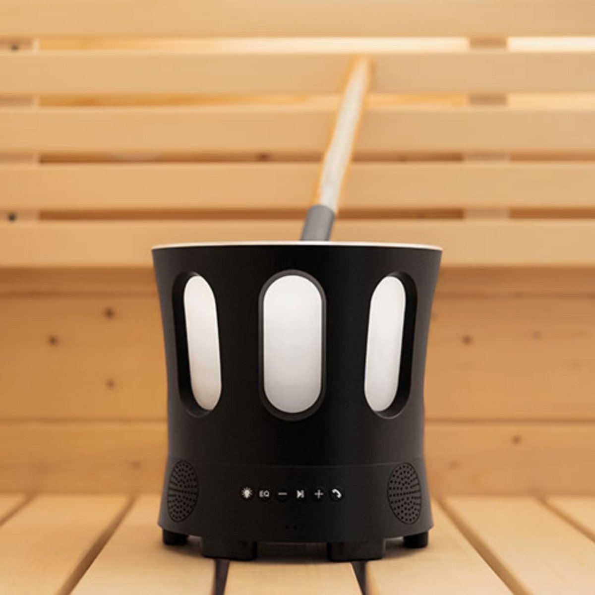 SaunaLife SaunaZone black speaker bowl with matching ladle on wooden bench.