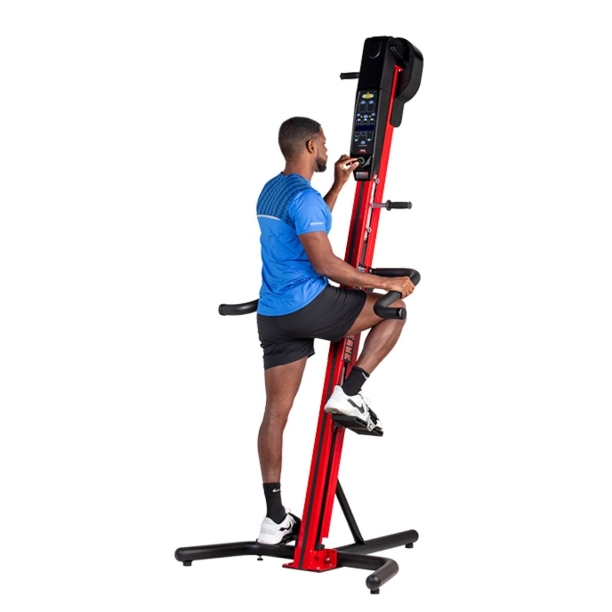 Man exercising on the VersaClimber SM-M Magnetic in red and black finish, demonstrating full-body zero-impact cardio and strength training.