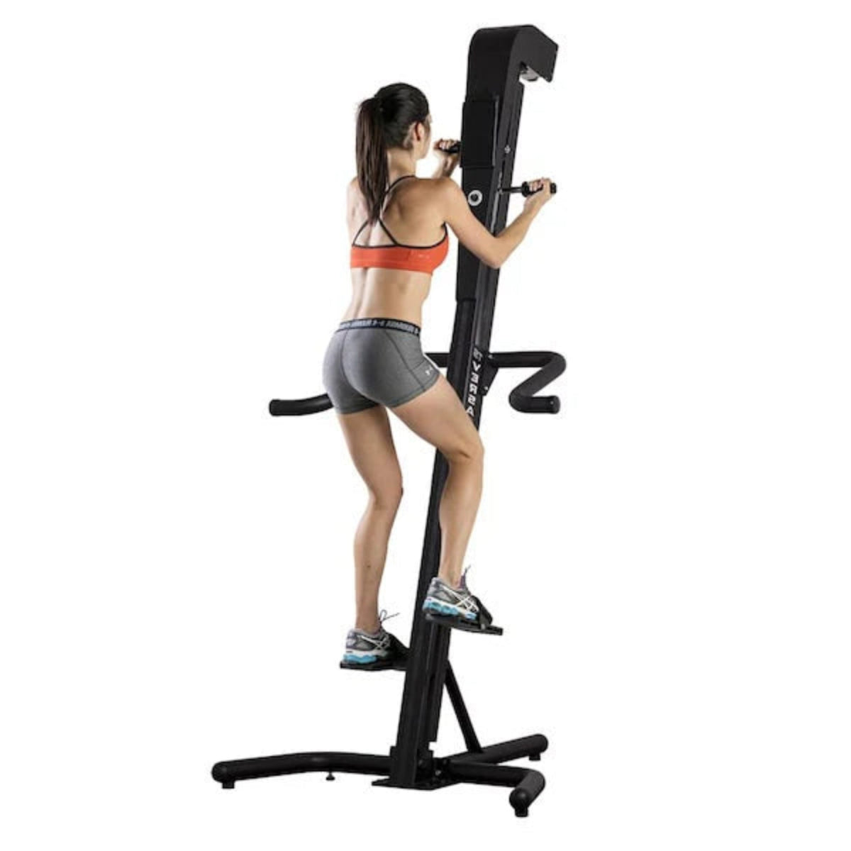 Woman exercising on the VersaClimber TS-A Aerobic vertical climbing machine, performing a total-body zero-impact cardio workout.