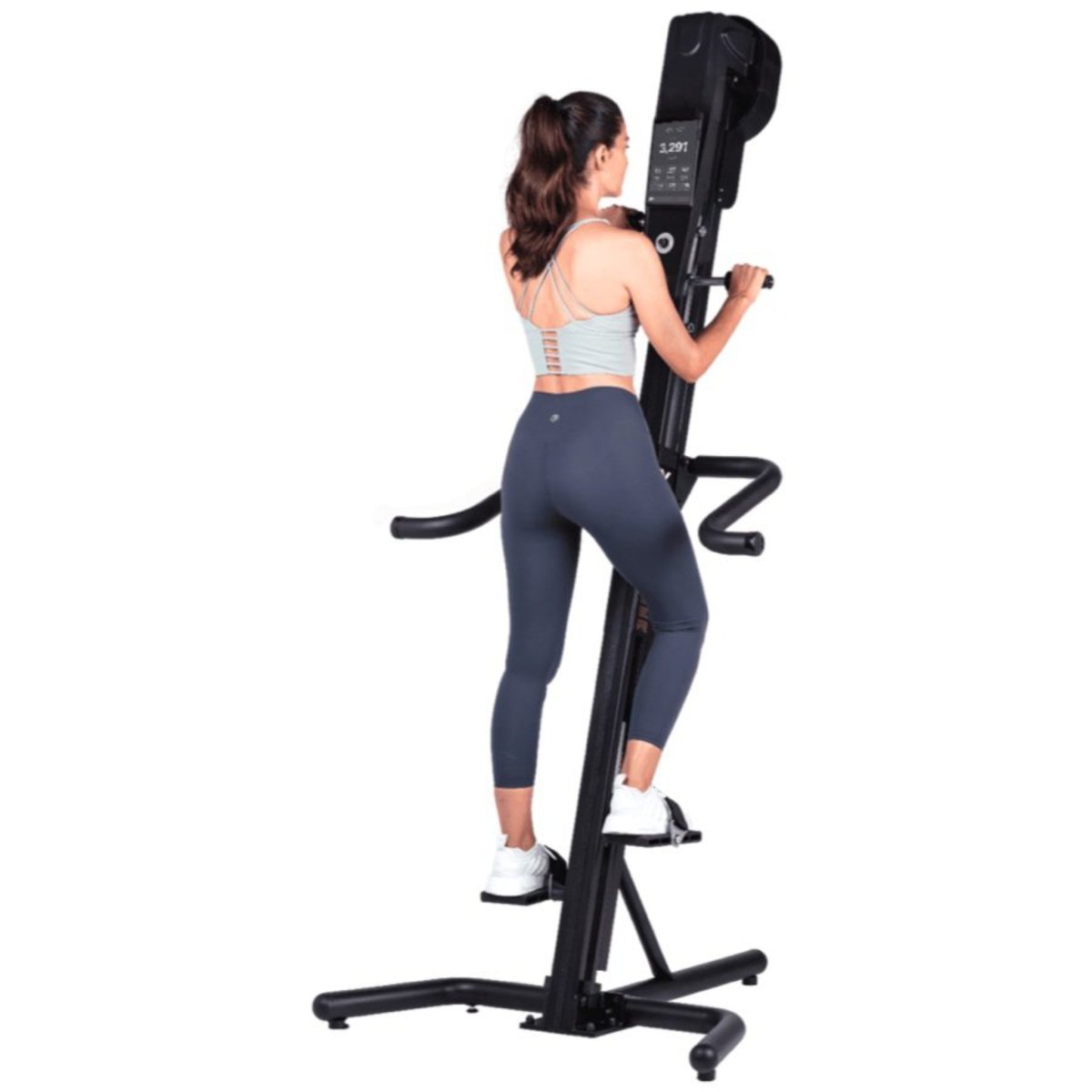 Woman training on the wall-mounted VersaClimber TS-M Magnetic in black, performing a full-body zero-impact cardio workout.
