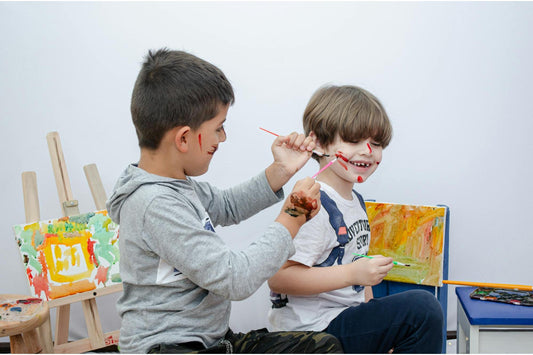 two children having fun with paint and living in the present moment