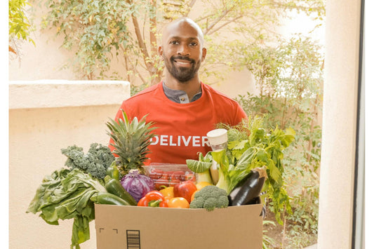 man holding a variety of vegetables which can support his digestive health