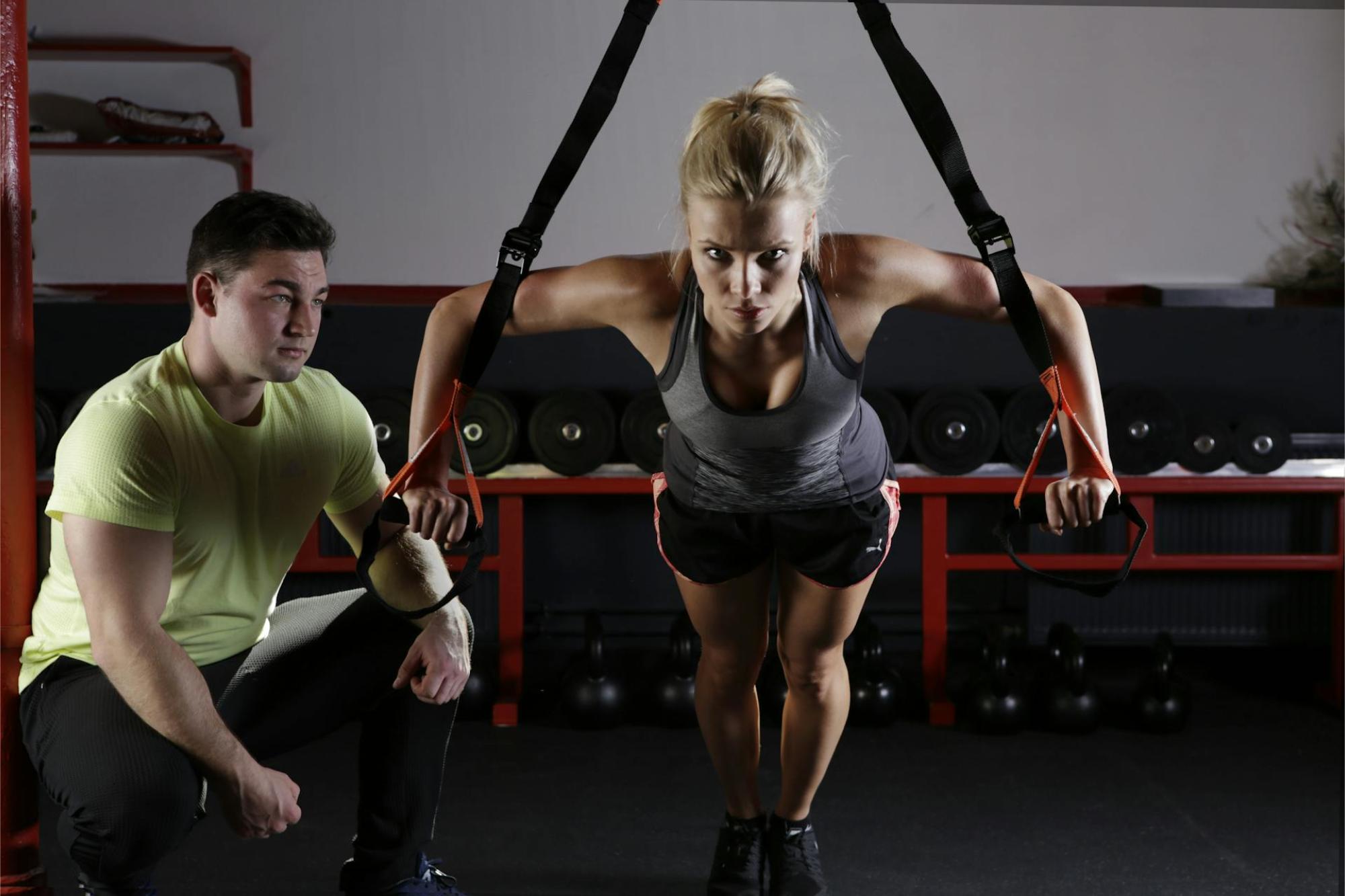 Woman using a fitness band in a home wellness gym