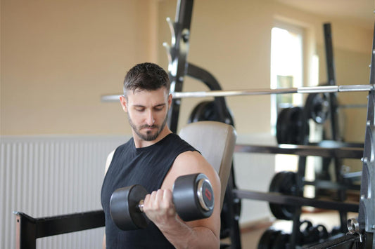man training in gym with barbells