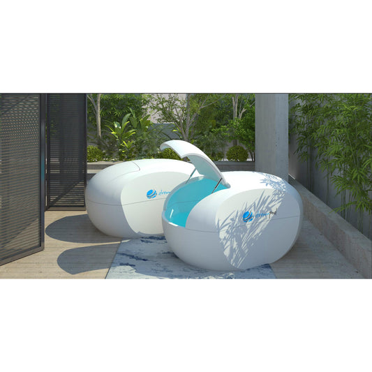 Modern outdoor pool with white shell and blue interior, designed for backyards and wellness spaces, surrounded by greenery