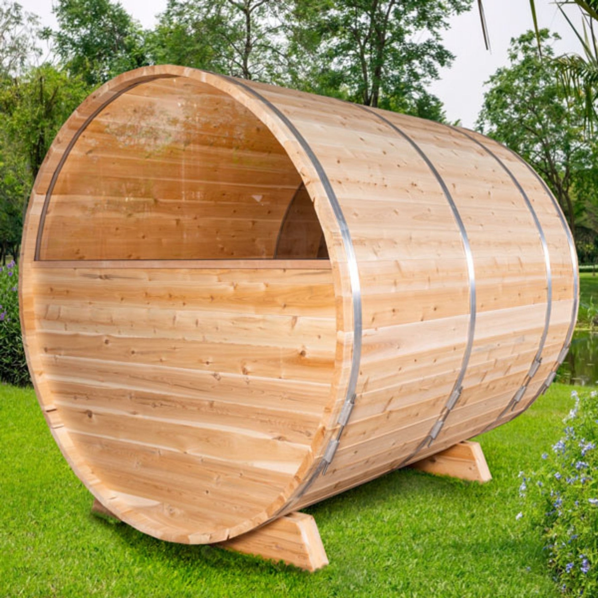 Wooden barrel sauna rear view showing curved cedar paneling on a grassy outdoor area