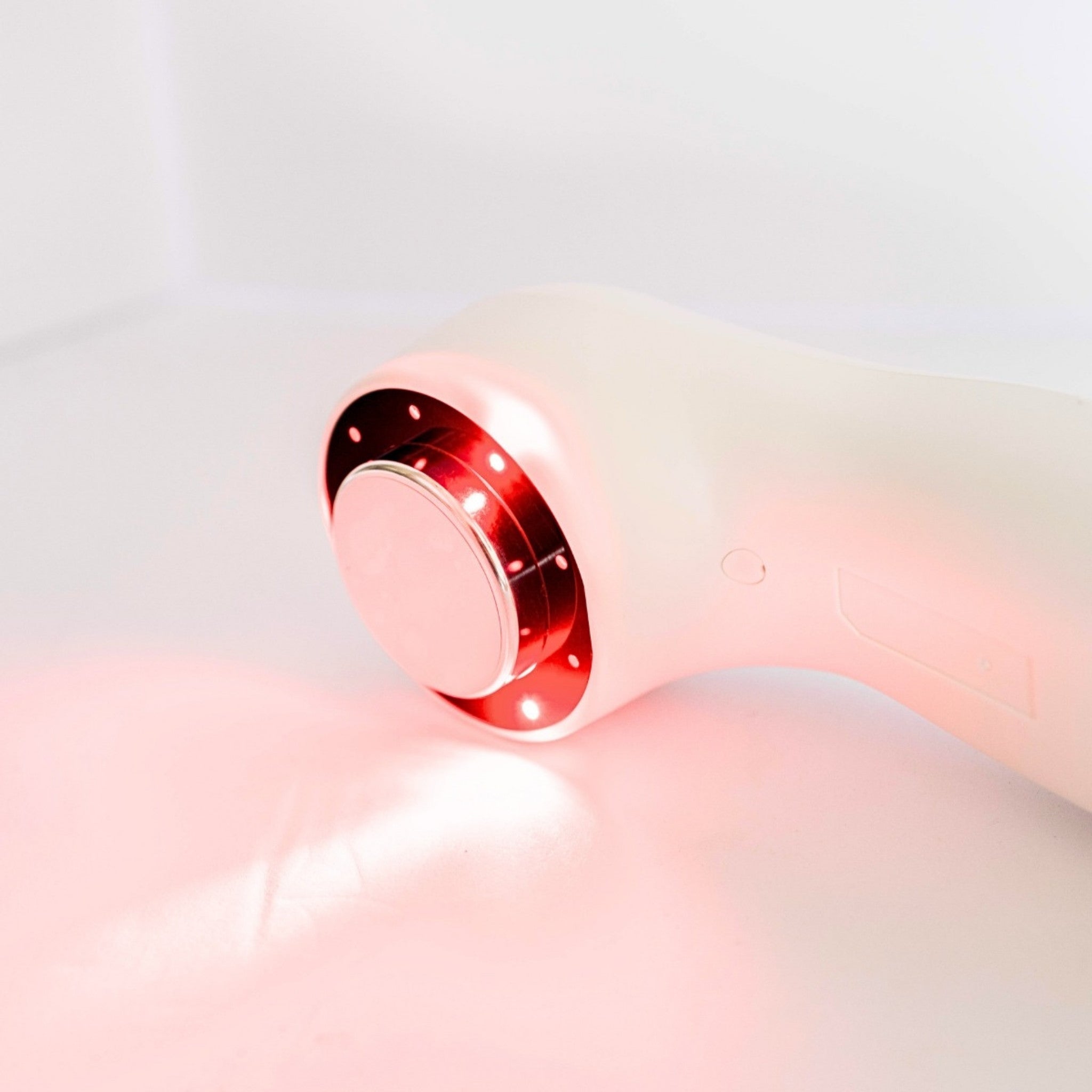 Oceanus America Lasonic Dual Therapy Ultrasound device close-up of glowing red light therapy head on white background