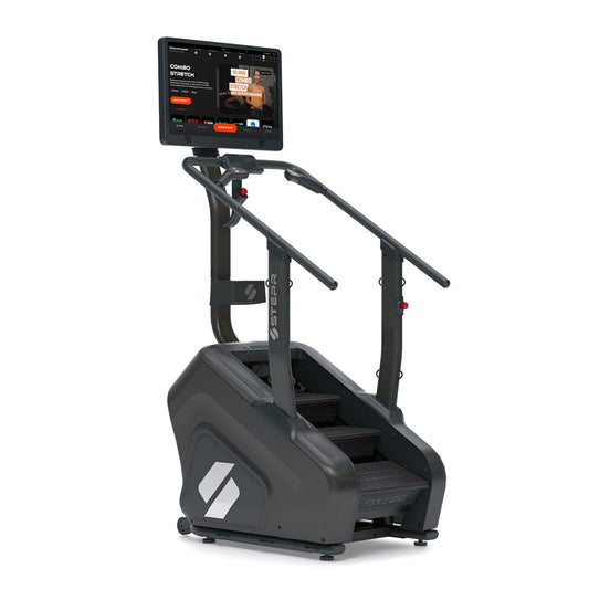 STEPR+ stair climber with large HD touchscreen display, compact footprint, and sturdy handrails on a white background.