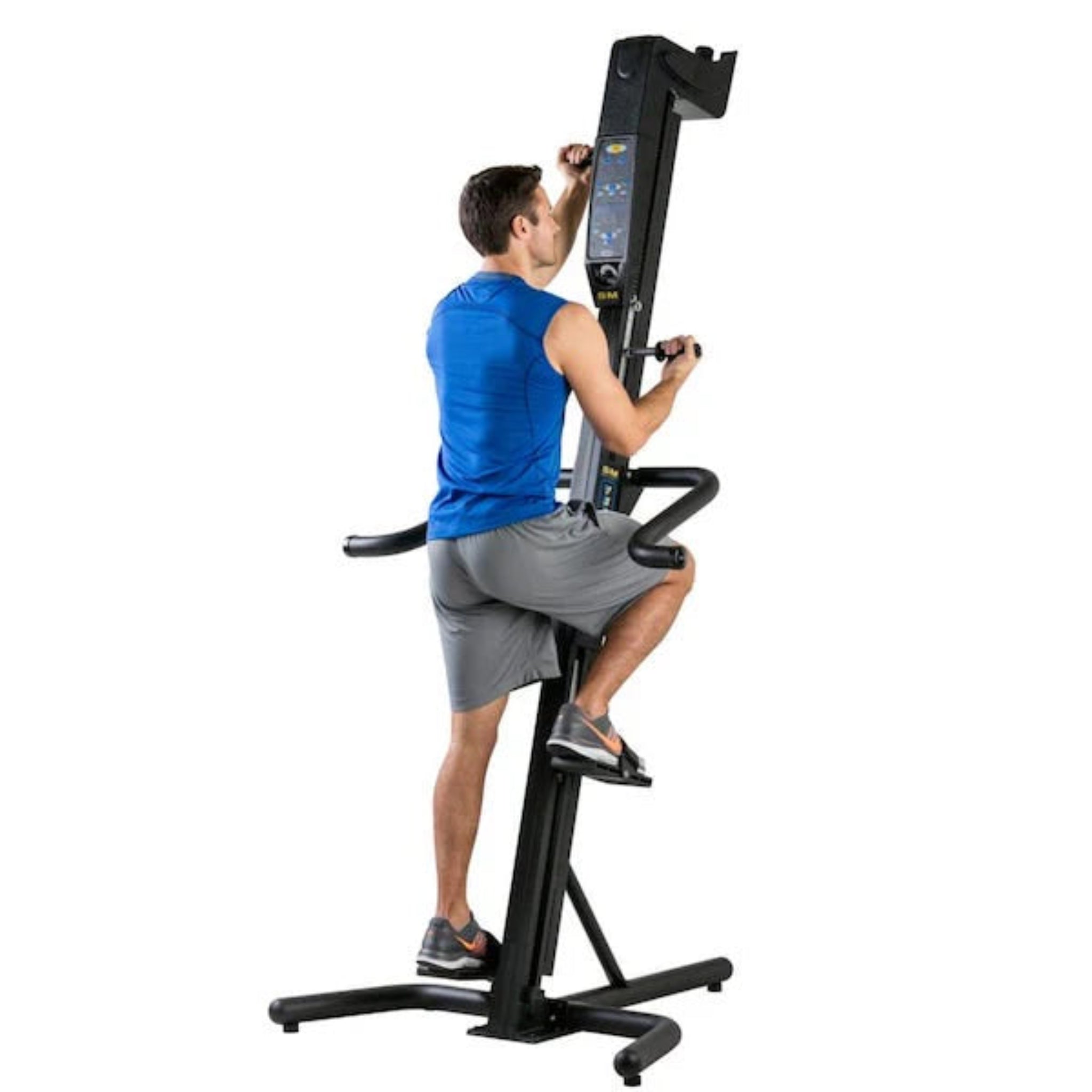 Man using the VersaClimber SM-A Aerobic vertical climbing machine for a full-body cardio workout in a home gym setting.