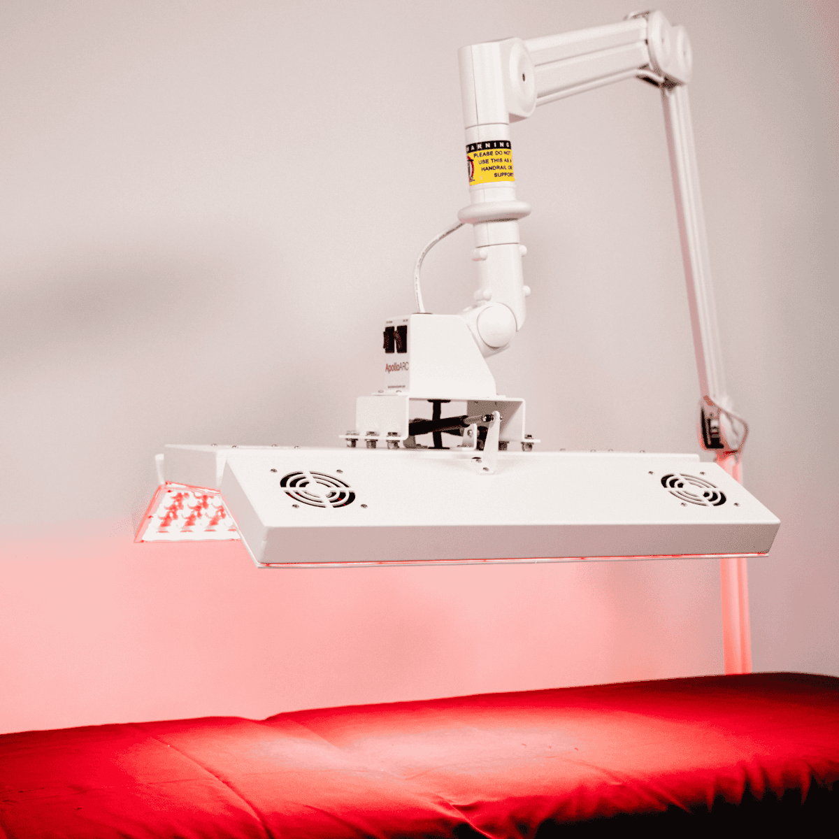 ApolloARC Premier Red Light Therapy System with adjustable arm for skin rejuvenation and recovery.