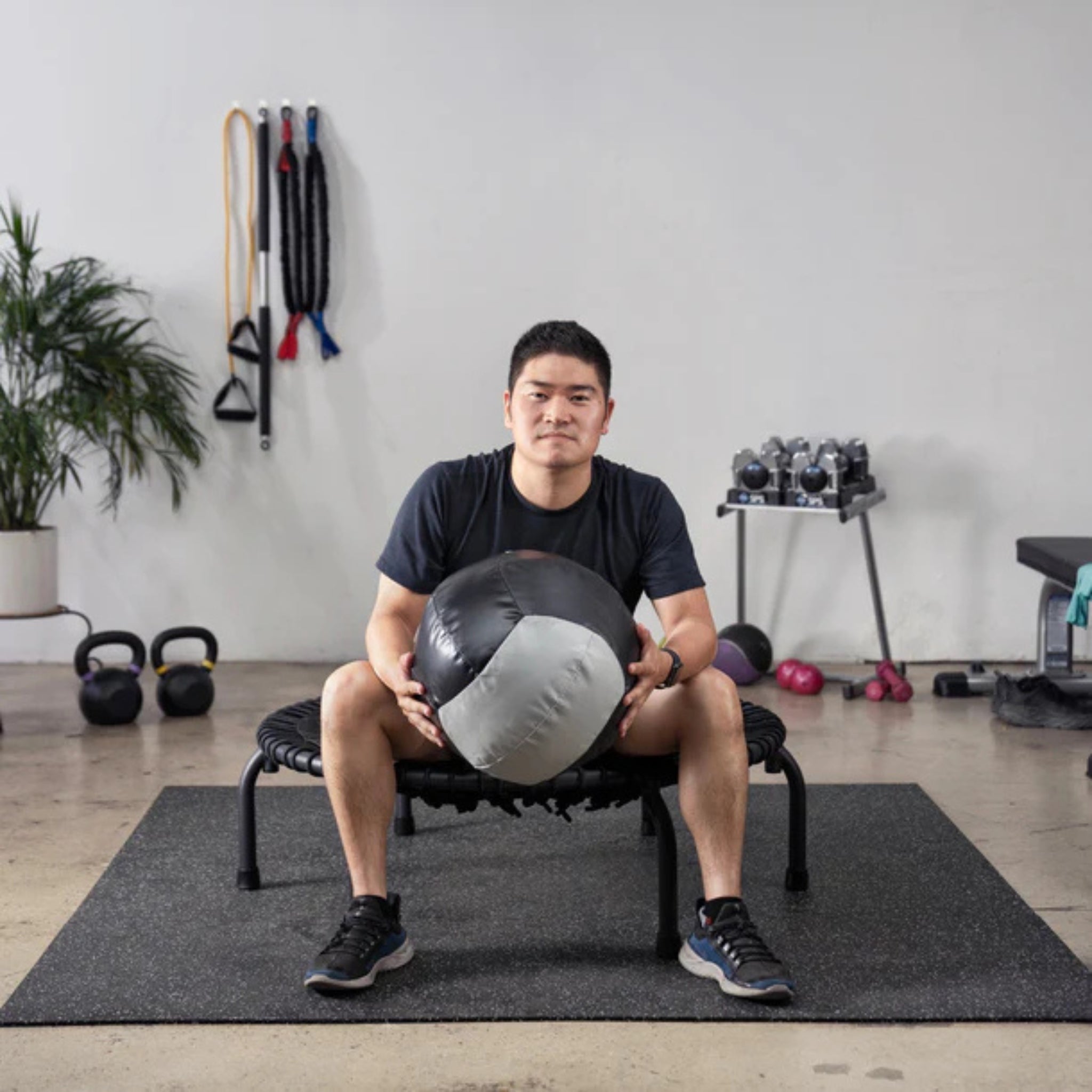 Man training with Dynamax medicine ball for strength and endurance