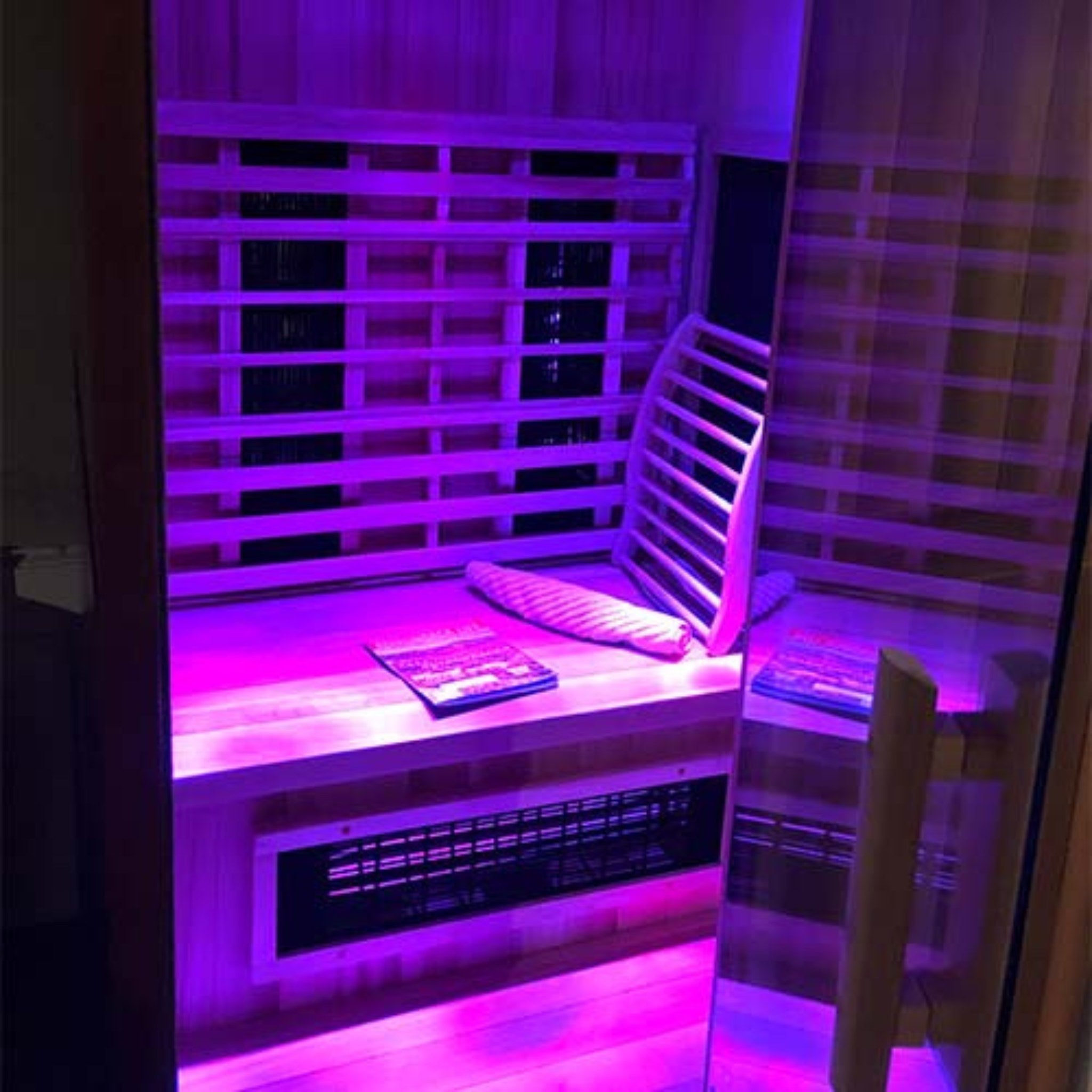 Finnmark FD-2 infrared sauna interior with purple lighting and wooden bench.
