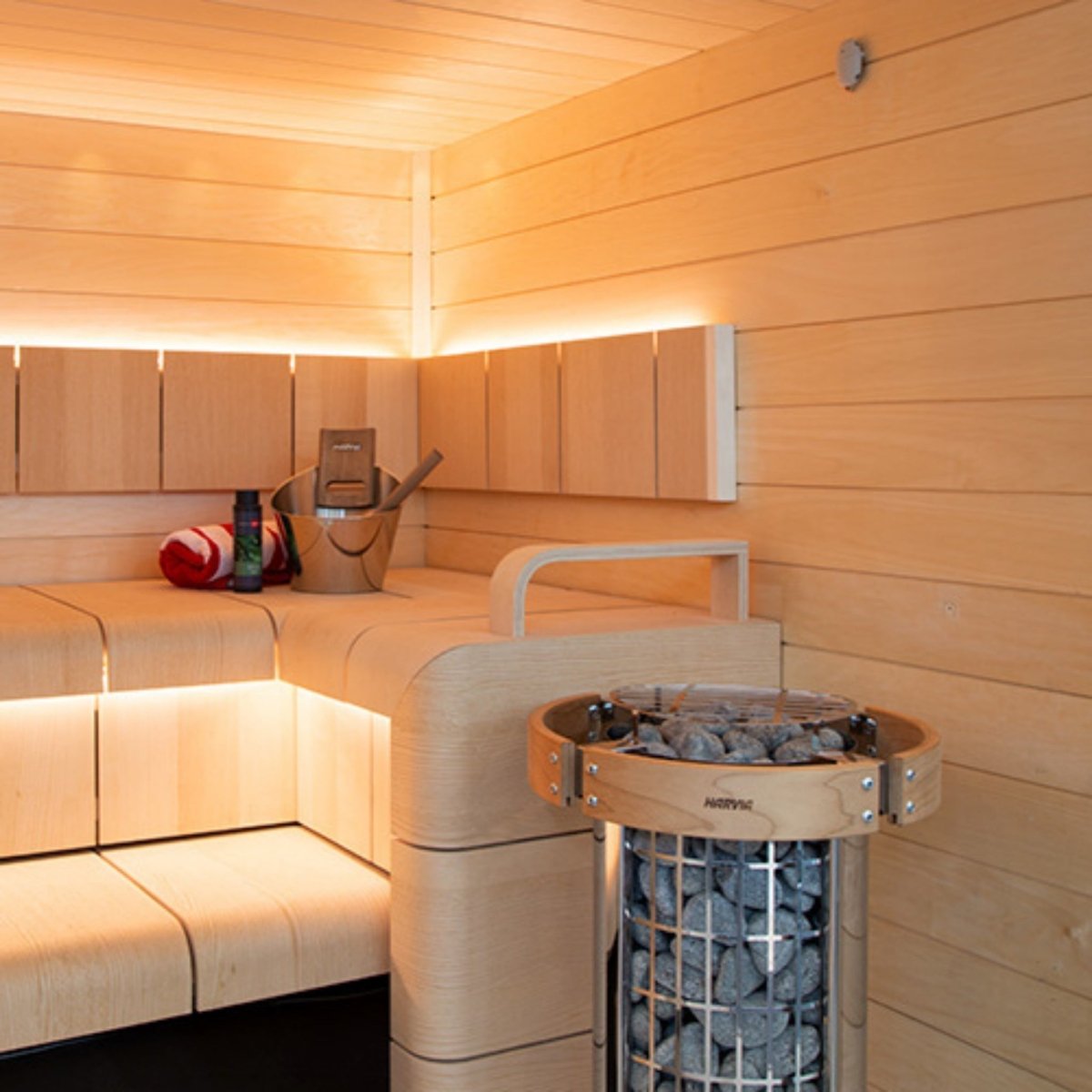 Harvia Cilindro PC60E sauna heater installed inside traditional wood sauna