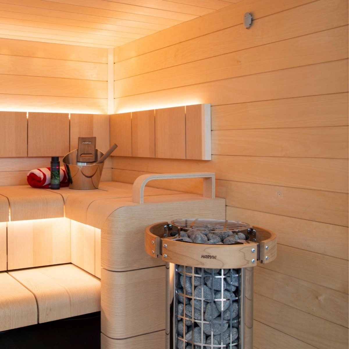 Harvia Cilindro PC90 sauna heater installed inside a traditional wood sauna