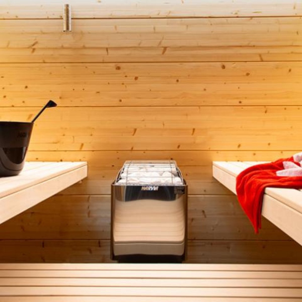 Harvia KIP80W sauna heater installed inside a traditional wood sauna