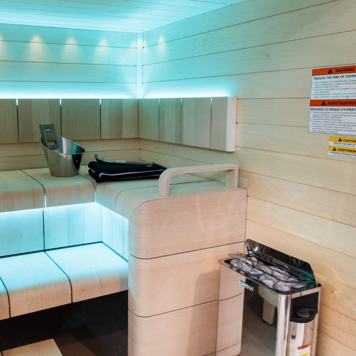 Harvia The Wall SWS80 electric sauna heater installed in sauna with ambient lighting