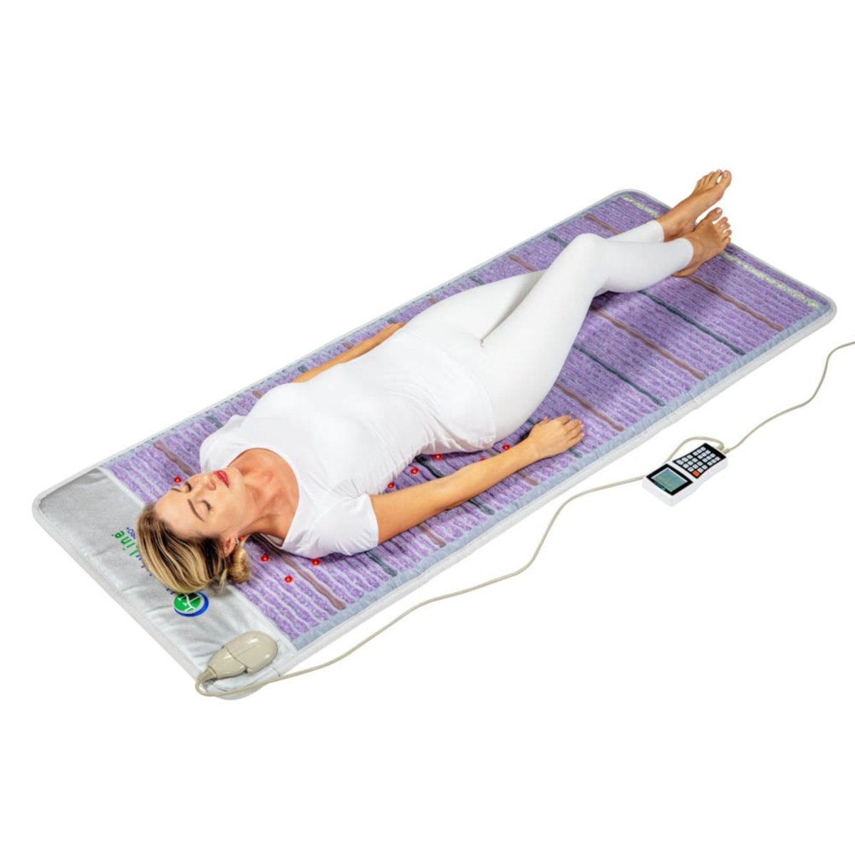 Person using HealthyLine Platinum PEMF infrared heating mat with gemstones and handheld controller