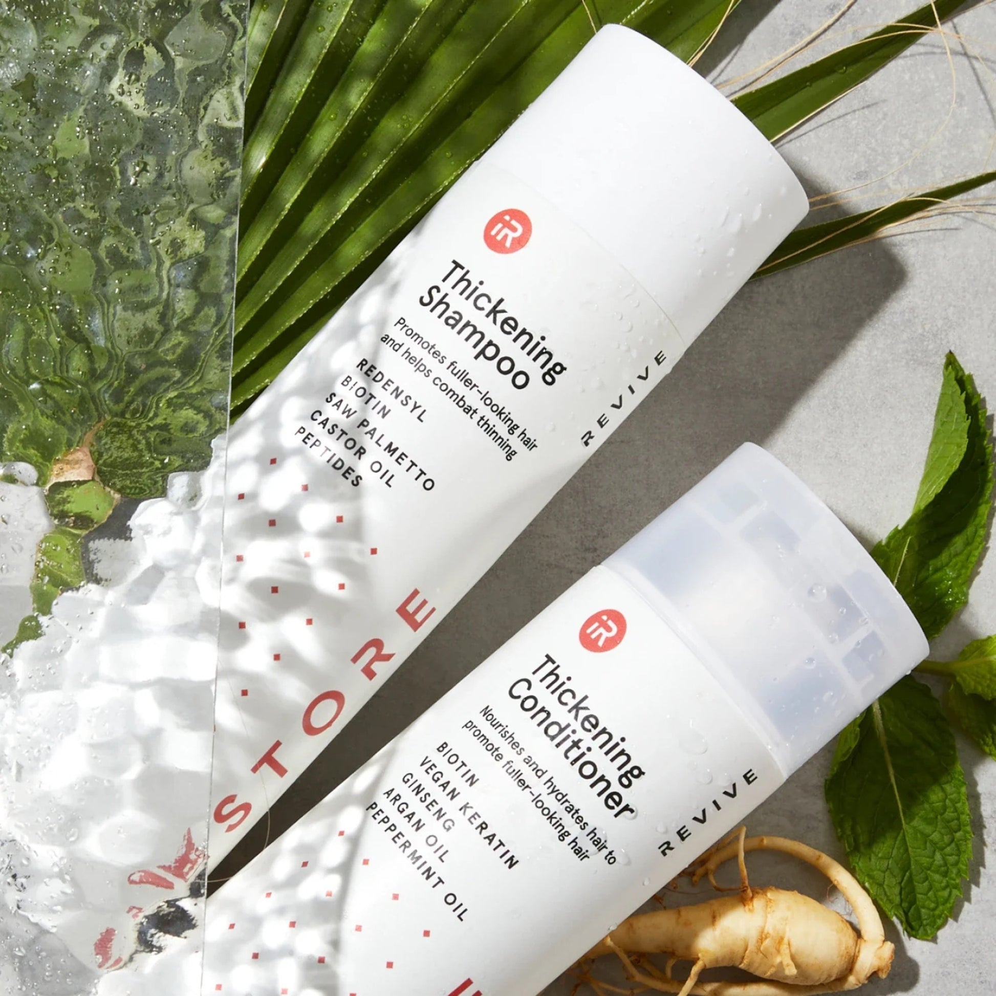 iRestore Anti-Thinning Shampoo bottles displayed with aloe and green plant