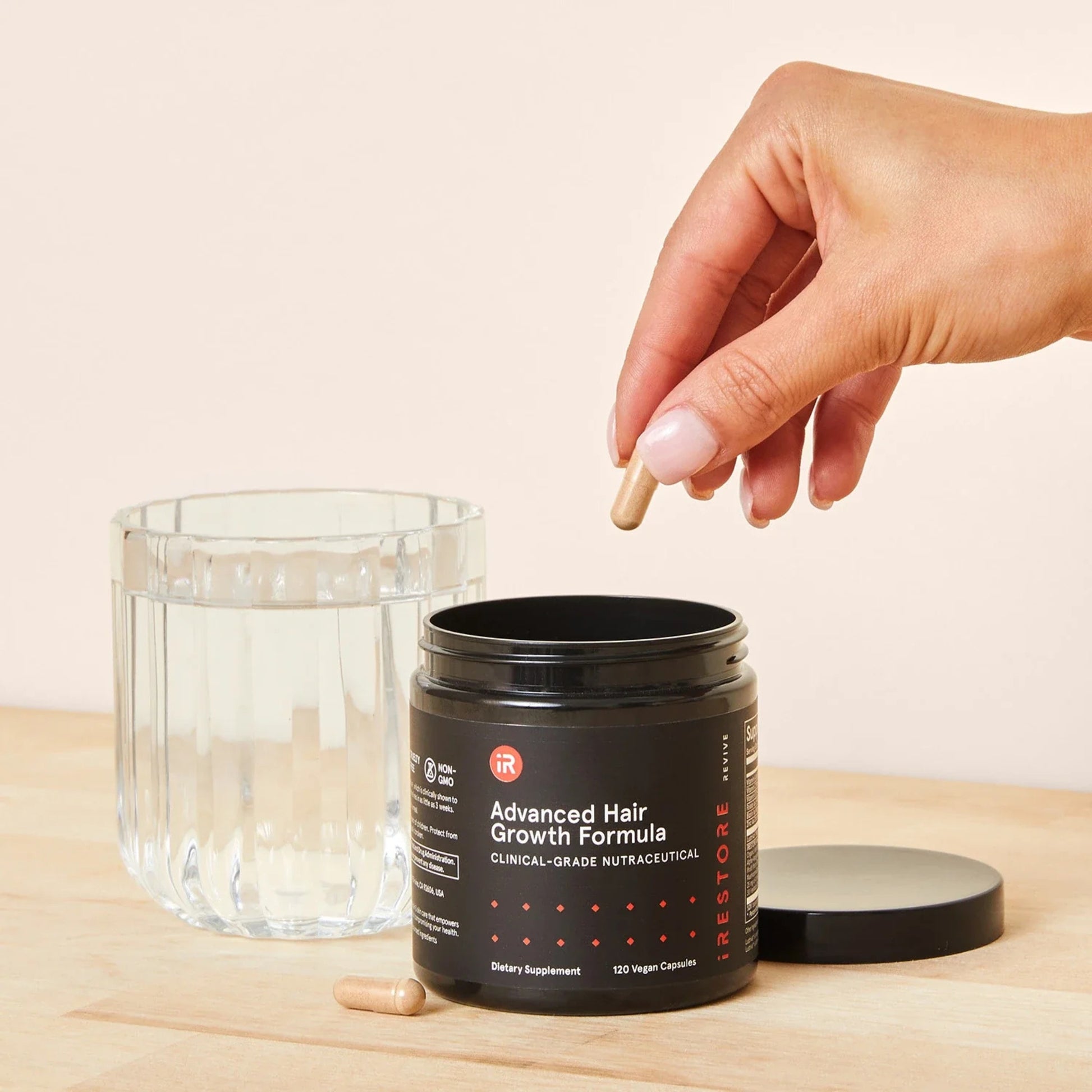 Stacked iRestore Revive Advanced Hair Growth Formula jars for product showcase