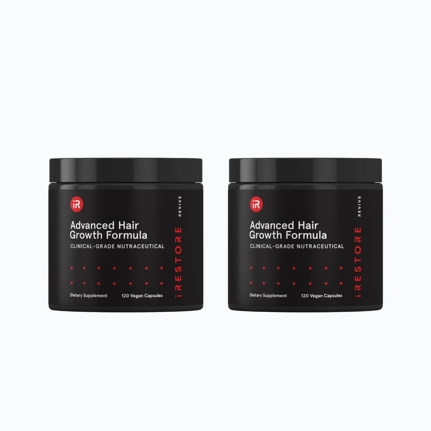 Hand placing iRestore Revive Advanced Hair Growth Formula supplement jar on table
