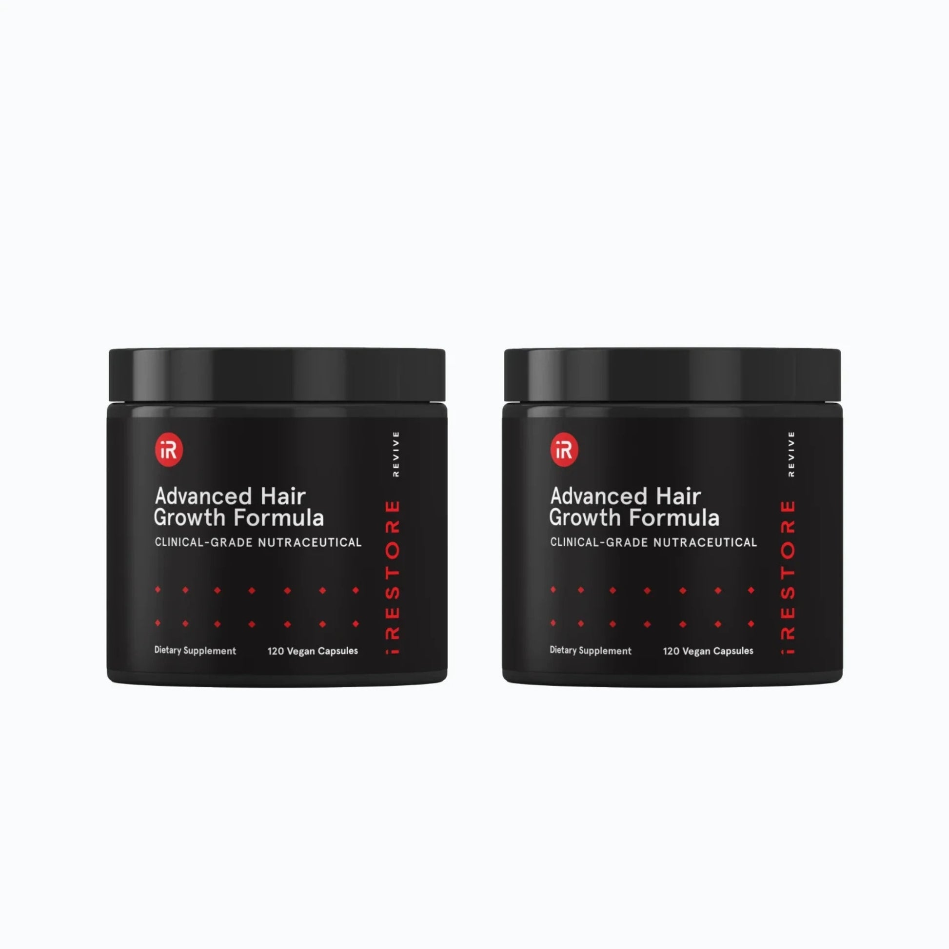 Hand placing iRestore Revive Advanced Hair Growth Formula supplement jar on table
