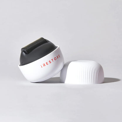 Smiling woman using iRestore scalp massager for stress relief and scalp health