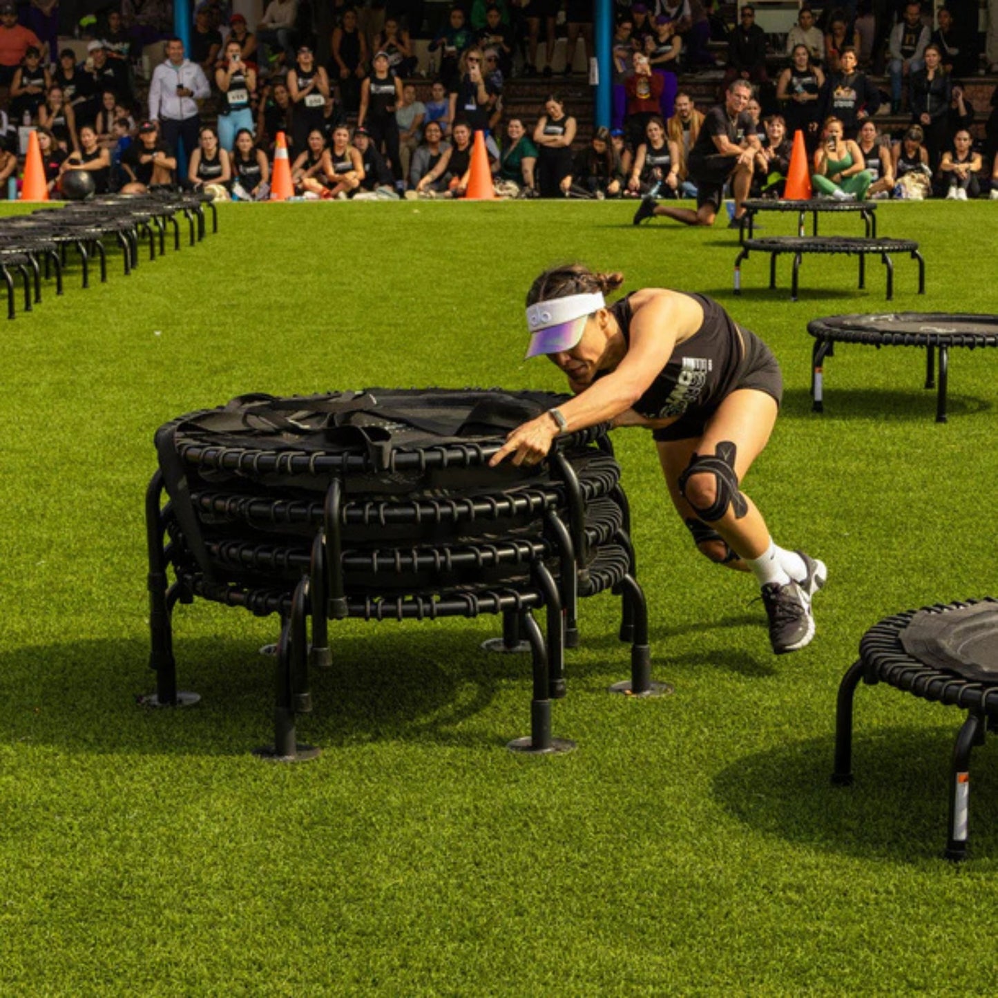 Outdoor stack of Jumpsport trampolines supported by replacement leg sets