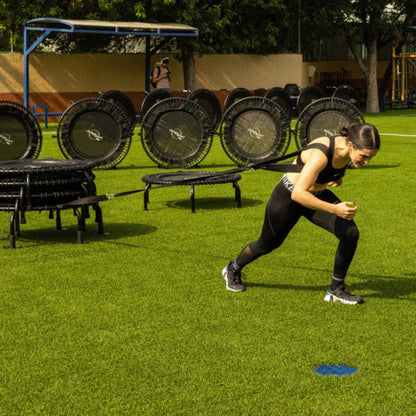 Athlete training outdoors on Jumpsport trampoline with replacement leg set
