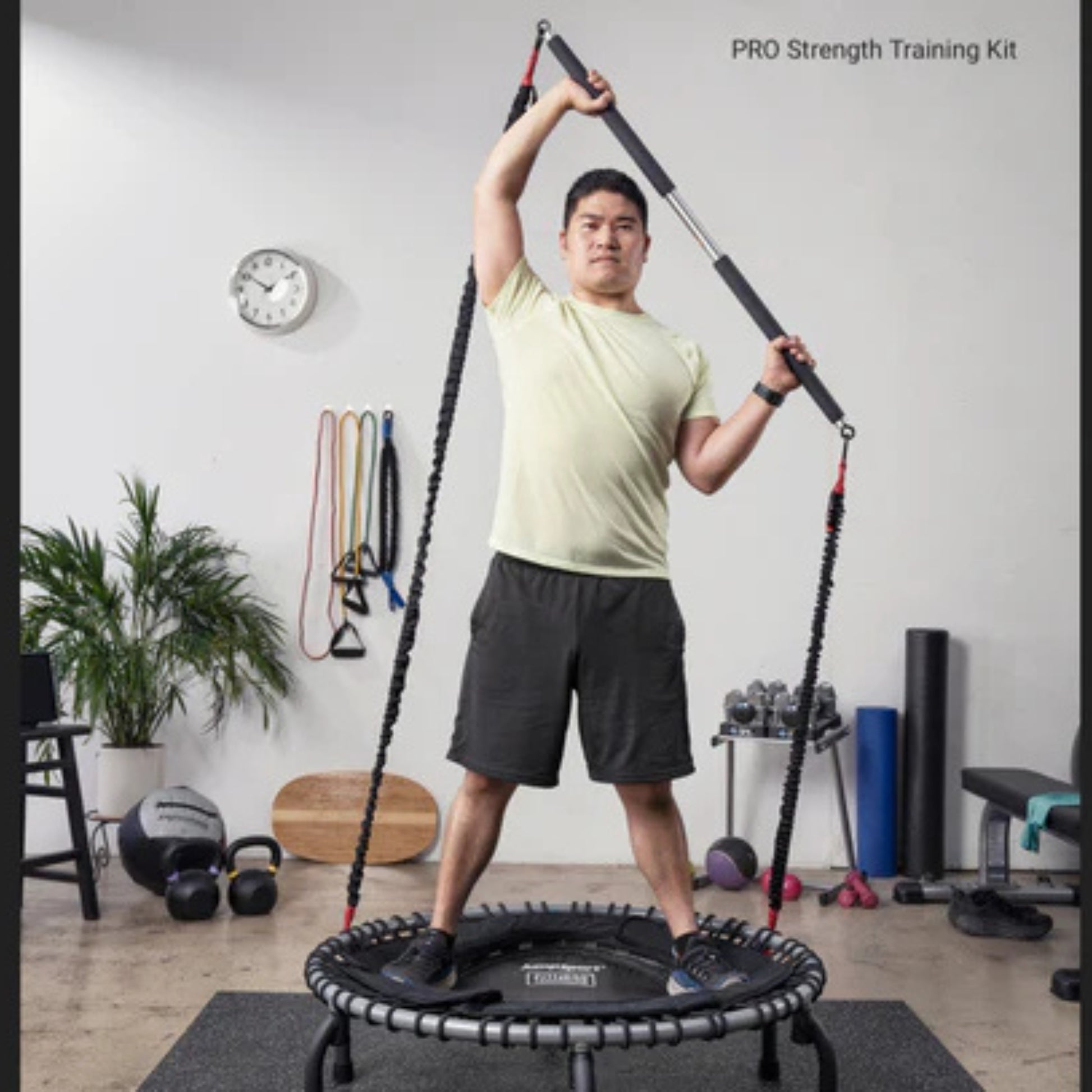 Athlete using Jumpsport trampoline resistance cords for strength training indoors